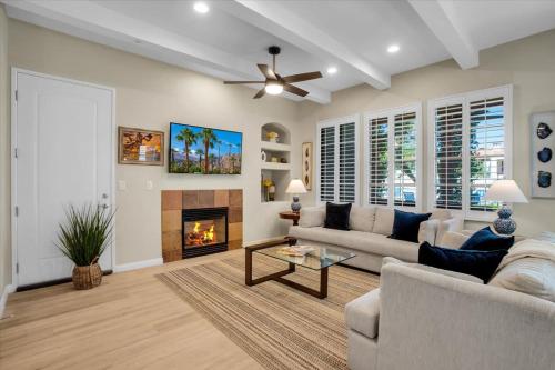 a living room with a couch and a fireplace at Modern LQ 3BR Getaway Steps to pool & spa in La Quinta