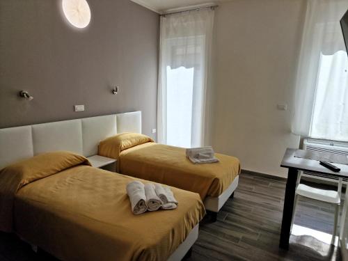 a hotel room with two beds with slippers on them at Berica Alloggi Turistici in Vicenza