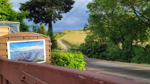 a painting in a wooden box on the side of a road at L'Orchidée chambres d'hôtes in Hounoux