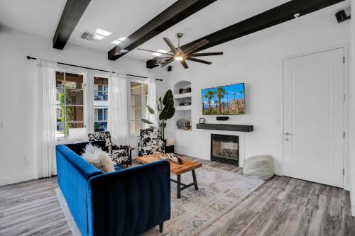 a living room with a blue couch and a fireplace at Remodeled Desert Hideaway #A in La Quinta