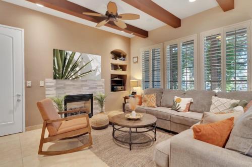 a living room with a couch and a ceiling fan at Alluring Desert Haven in La Quinta #A in La Quinta