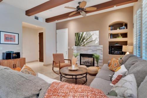 a living room with a couch and a fireplace at Alluring Desert Haven in La Quinta #A in La Quinta