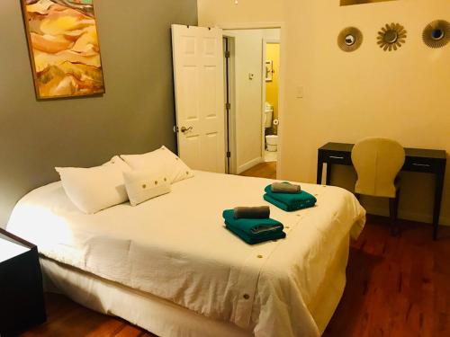 a bedroom with a bed with two towels on it at Stunning Empire State 3 BR'S in Union City