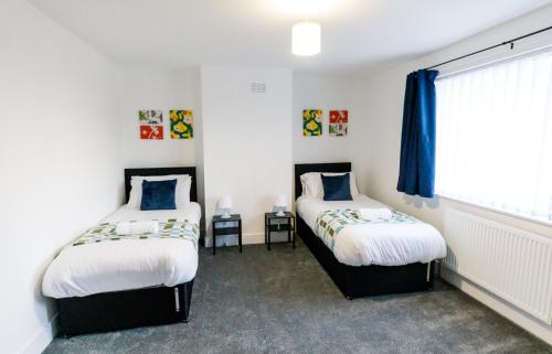 a bedroom with two beds and a window at Spacious 2Bed - Great for Contractors - Driveway&Garden in Pallion