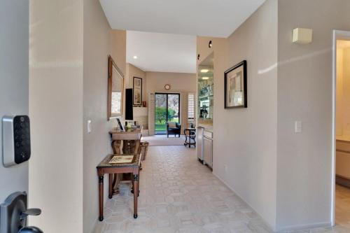 a hallway of a home with a table and a room at Spacious Villa with Spectacular Golf Course Views in La Quinta