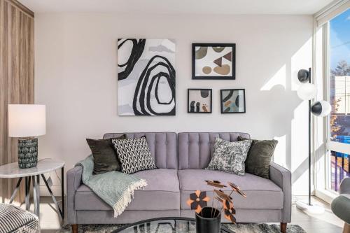 a living room with a purple couch and a table at Perch - Dayton Dream in Seattle