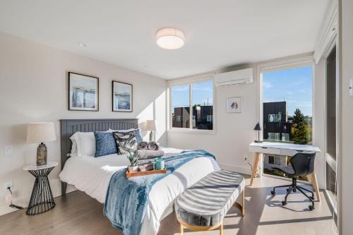a bedroom with a bed and a desk and a window at Perch - Dayton Dream in Seattle