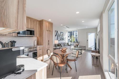 a kitchen and dining room with a table and chairs at Perch - Dayton Dream in Seattle