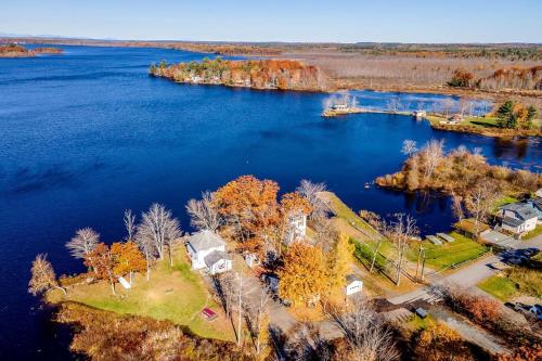 an aerial view of a house on an island in the water at Lakeside Retreat in Orono, Maine in Orono