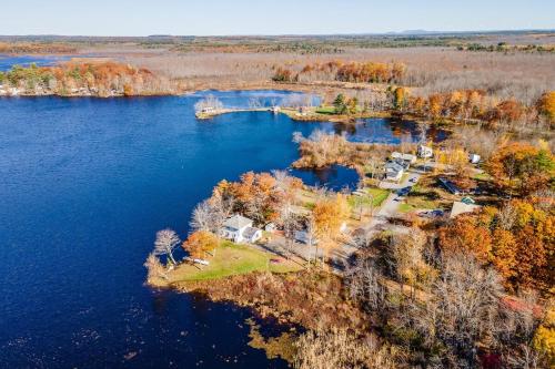 an aerial view of a house on an island in the water at Lakeside Retreat in Orono, Maine in Orono