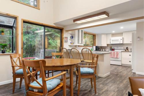 a kitchen and dining room with a wooden table and chairs at Perch - Rhododendron Loft in Coupeville