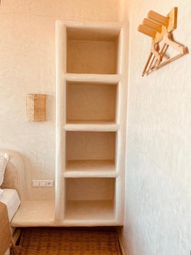 a built in book shelf in a room at Amazigh Home in Mirleft