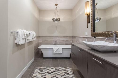 a bathroom with a tub and a sink and a mirror at Snowcreek #754 - Phase V in Mammoth Lakes