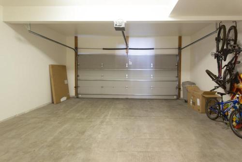 a garage with two garage doors and bikes in it at Snowcreek #754 - Phase V in Mammoth Lakes