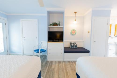 a bedroom with two beds and a tv at The Edgewater in Old Orchard Beach