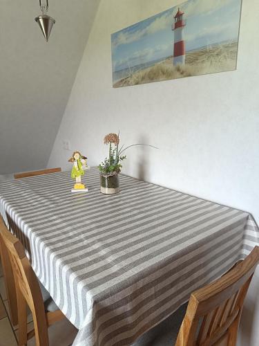 a dining room table with a striped table cloth at Marschblick in Südermarsch