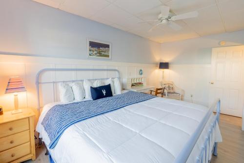 a bedroom with a large white bed with a blue blanket at The Edgewater in Old Orchard Beach