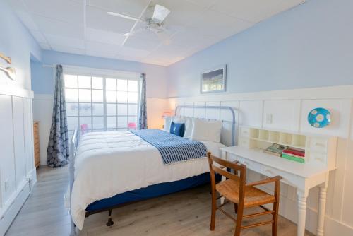 a bedroom with a bed and a desk and a chair at The Edgewater in Old Orchard Beach