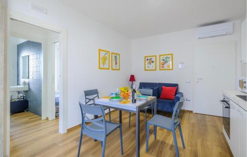 a dining room and living room with a table and chairs at Albamare in Alba Adriatica