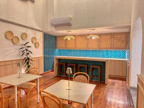 a room with tables and chairs and a fireplace at Hotel Boutique Casa Alebrije in Mexico City
