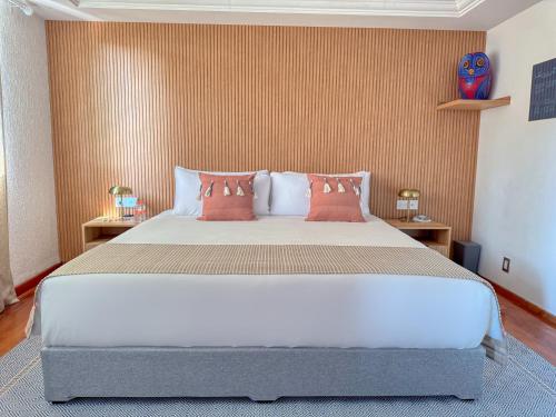 a bedroom with a large bed with red walls at Hotel Boutique Casa Alebrije in Mexico City