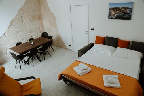 a bedroom with a bed and a table and chairs at [Otranto in 10 min]-Free Parking in Maglie