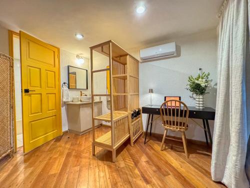 a room with a desk and a yellow door at Hotel Boutique Casa Alebrije in Mexico City
