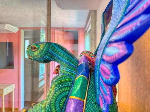 a colorful statue of a lizard with wings at Hotel Boutique Casa Alebrije in Mexico City
