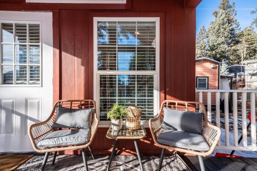 a porch with two chairs and a table at Pikes Peak Heaven's Retreat! in Woodland Park