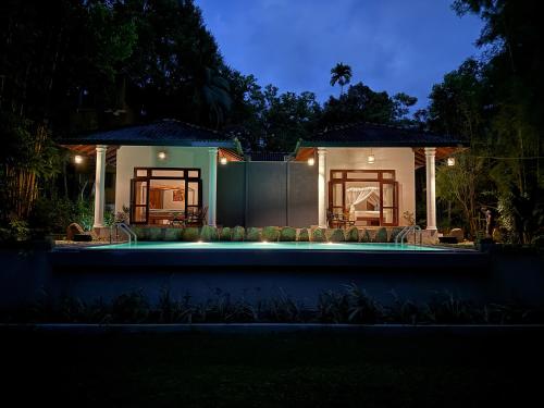 a house with a swimming pool at night at The Lush Unawatuna in Unawatuna