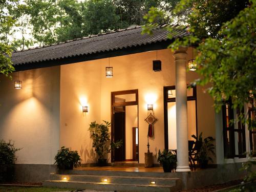 a house with a porch with lights on it at The Lush Unawatuna in Unawatuna