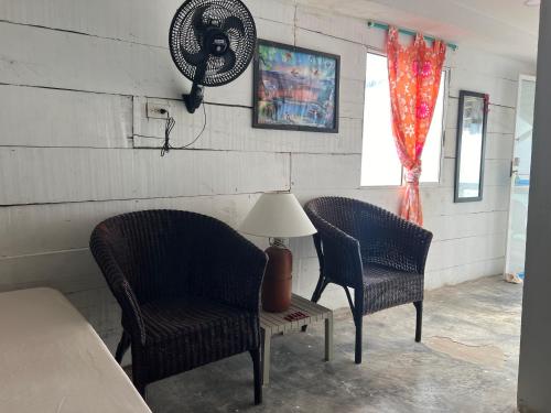 two chairs and a table with a lamp in a room at AcapulcoBeach in Playa Blanca
