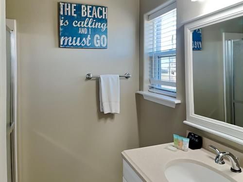 a bathroom with a sink and a mirror at Bishops Beach in Galveston