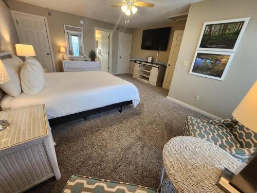 a bedroom with a large bed and a living room at North Shore Inn TC 302 in Traverse City