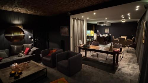a living room with a couch and a table at Zevende hemel in Zeebrugge
