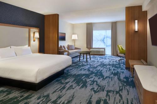 a hotel room with a bed and a couch at Fairfield by Marriott Inn & Suites Orillia in Orillia