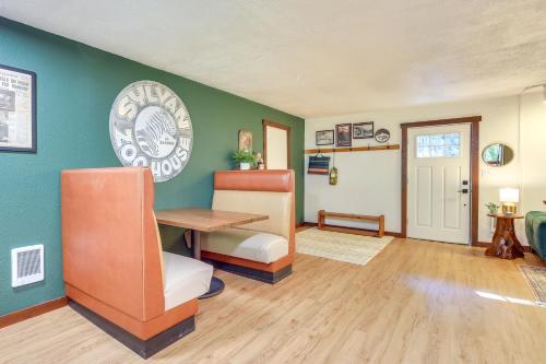 a living room with green walls and a table at Close to Mt Hood Skibowl Retro Rhododendron Cabin in Rhododendron