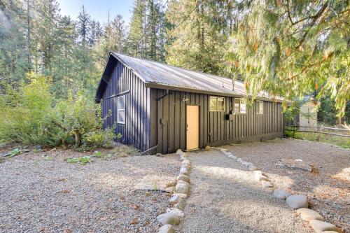 a brown building with a door in a yard at Close to Mt Hood Skibowl Retro Rhododendron Cabin in Rhododendron
