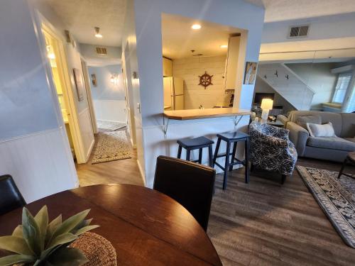 a dining room and living room with a table and chairs at North Shore Inn TC 307 in Traverse City