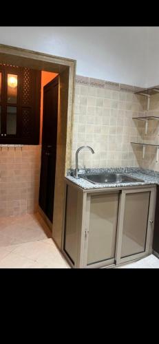 a kitchen with a sink and a counter top at Cozy appartment in Marrakech