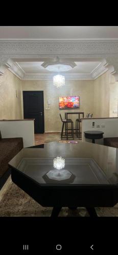 a living room with a couch and a table at Cozy appartment in Marrakech