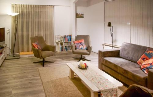 a living room with a couch and two chairs and a table at Amazing Home In Workum With Wifi in Workum