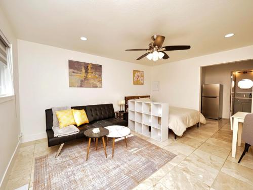 a living room with a couch and a table at Molivu Homes Studio - PetFriendly - King Bed - W-D in Los Gatos