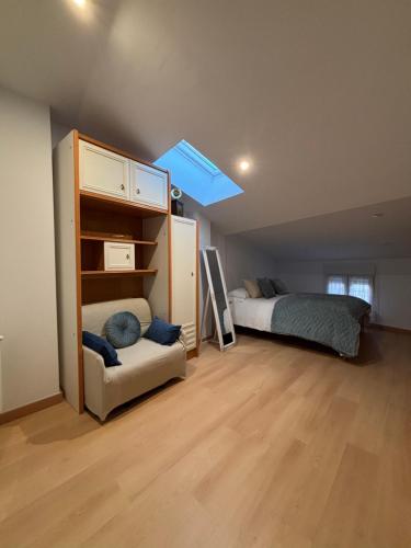a bedroom with a bed and a bed and a skylight at Puerta del Sol in Aranzueque