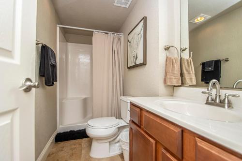 a bathroom with a white toilet and a sink at Dock Holiday! in Hot Springs