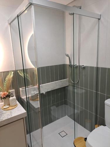 a bathroom with a glass shower with a toilet at Metrô Studio Alto do Ipiranga in Sao Paulo
