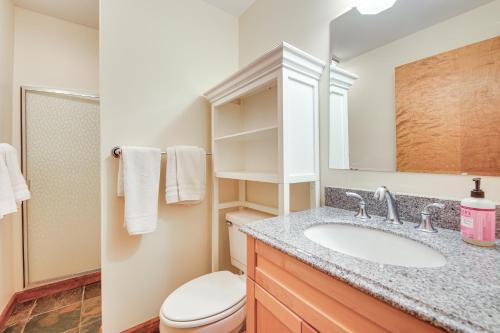 a bathroom with a sink and a toilet and a mirror at 1 Mi to Killington Resort Townhome with Dry Sauna! in Killington
