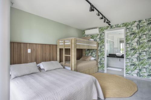 a bedroom with a bed and a mirror at Casa Flamingos - by Pipa Praia House in Pipa