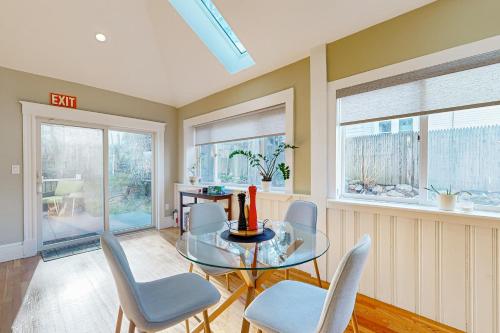 a dining room with a glass table and chairs at Urban Oasis in Newton in Newton