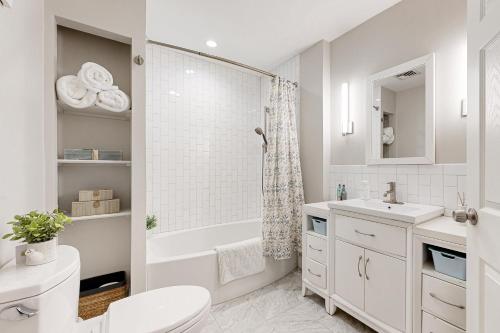 a bathroom with a toilet and a tub and a sink at Urban Oasis in Newton in Newton